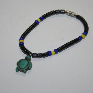 Cute little hematite bracelet with blue and yellow beads and turtle charm